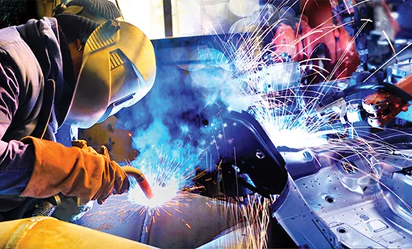 A student welding in class
